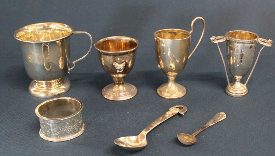 Silver christening cup, egg cup, 2 small trophies & napkin ring and christening spoon marked