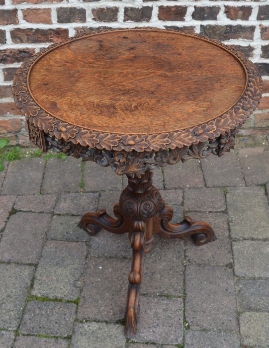 Rotating carved wooden pedestal table
