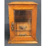 Edwardian oak smokers cabinet, with bevelled glass door and two internal drawers