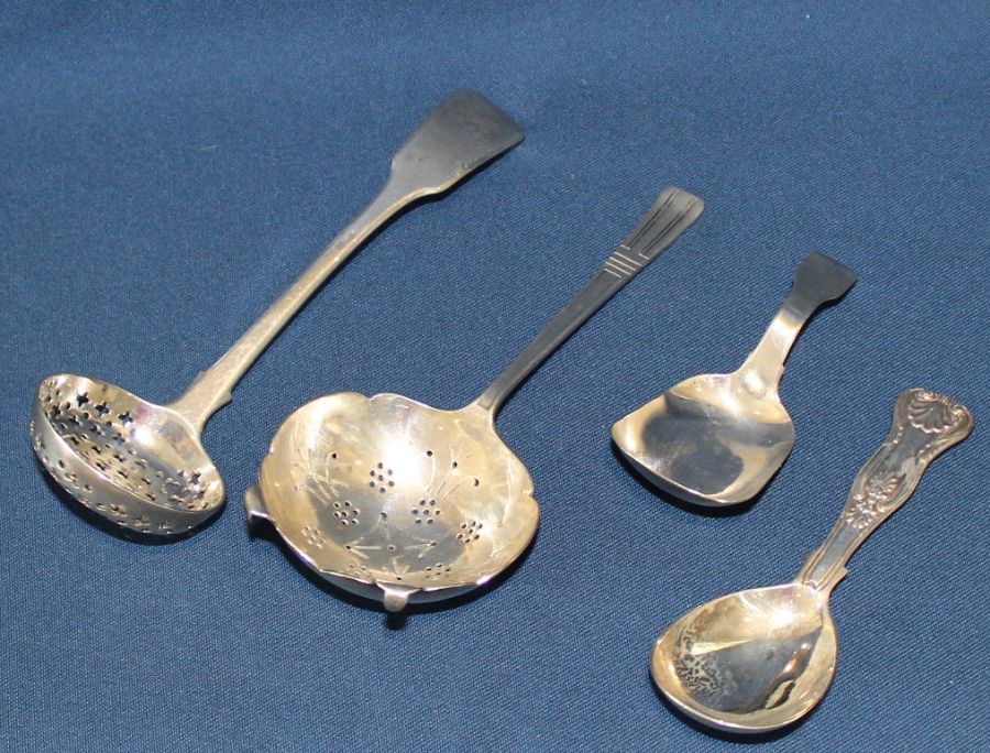 Georgian silver tea strainer, London 1827 & one other London 1942 and 2 silver caddy spoons London