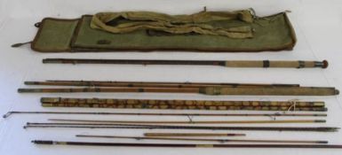 Collection of vintage fishing rods including cane with brass with canvas carry bag and a gun