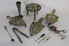 Brass trivets, white metal candle snuffer, nutcracker, vase and boot hooks one with Whitby jet