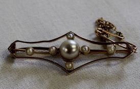 Gold bar brooch set with seed pearls and central faux pearl, appears to be marked 15, 3.01g