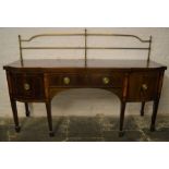 Large George III break front sideboard with brass rail on tapering legs with spade feet in