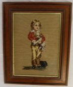 Framed needlepoint depicting Victorian boy holding a dog, frame size 29cm x 37cm