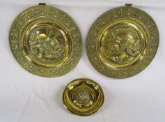 3 brass hanging plates 2 with helmeted soldiers and one with a lions head