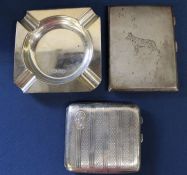 Silver engine turned cigarette case with engraved Alsatian decoration, one other cigarette case &