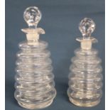 Pair of ribbed glass liqueur decanters with pontil marks approx. 21cm & 19cm tall including stopper