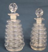 Pair of ribbed glass liqueur decanters with pontil marks approx. 21cm & 19cm tall including stopper