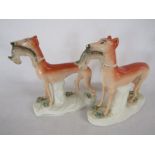 Pair of Staffordshire greyhounds with rabbits