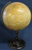 Early 20th century Geographia 12 inch terrestrial globe on turned ebonised stand with brass meridian