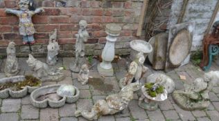 Various garden ornaments including gnomes and scarecrow