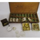 Wooden box containing watch parts including keys and rolled gold fob chain bars