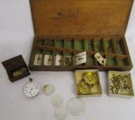 Wooden box containing watch parts including keys and rolled gold fob chain bars