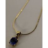 14k gold pendant set with blue Sri Lanka sapphire (0.81ct) on 18k gold chain (1.6g)