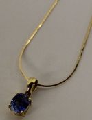 14k gold pendant set with blue Sri Lanka sapphire (0.81ct) on 18k gold chain (1.6g)