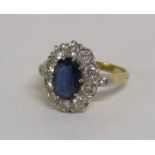 18ct gold sapphire and diamond cluster ring, the central claw set oval sapphire approximately 1.30ct