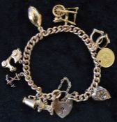 9ct gold charm bracelet with 9 charms (stamped 9ct or tested as) including a Peruvian 1/5 De