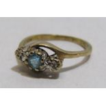 Tested as 9ct gold blue topaz with 2 illusion set diamonds twisted shoulder ring - ring size M -