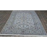 Cream ground Persian Kashan carpet, worn in corner295cm by 202cm