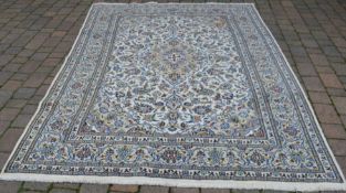 Cream ground Persian Kashan carpet, worn in corner295cm by 202cm