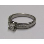 Platinum (tested as mark worn) ring set with square cut diamond solitaire .50ct and 5 diamonds to