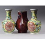 A sang de beouf glazed bulbous vase with handles, 11 3/4" high, and a pair of polychrome fruit