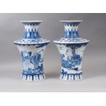 A pair of Chinese blue and white flared vases with figures in a landscape decoration, 16" high