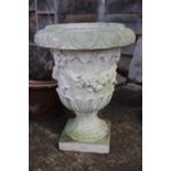 A cast stone urn with swag decoration, 22" high