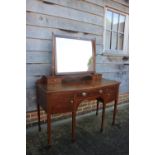 An Edwardian walnut, line inlaid and rosewood banded bowfront dressing table, fitted mirror over