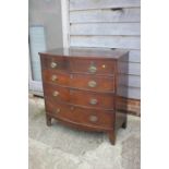 A mahogany bowfront chest of two short and three graduated long drawers with oval brass handles,