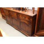 A Brights of Nettlebed oak dresser base of 18th century design, fitted three drawers over arched