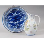 A Continental faience dish with blue flower decoration, 12" dia, and a Rouen faience jug with