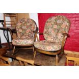 An Ercol spindle and Prince of Wales feathers splat back rocking chair with loose seat and back