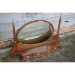 An Edwardian walnut satinwood banded box and line inlaid oval toilet mirror, on shaped base,