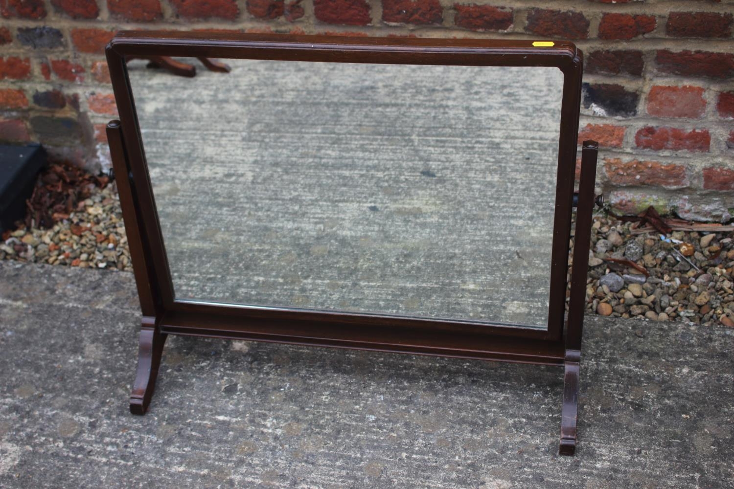 A 1930s mahogany rectangular swing frame toilet mirror, on splay supports, 26" wide x 22 1/2" high