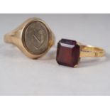 An 18ct gold and garnet single stone dress ring, size M, 3.4g, and a 9ct gold and enamelled