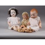 An Armand Marseille bisque headed doll, a Heubach Koppelsdorf bisque headed doll and two other dolls