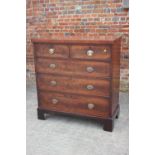 A 19th century figured mahogany chest of two short and three long graduated drawers with oval
