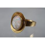 A yellow metal ring, set rough opal, size 5 1/2