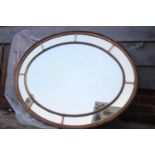 A Georgian design gilt framed oval wall mirror with sectional plate, 42" wide x 32" high