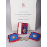 A 1953 Coronation medal and certificate, two 1937 Coronation medals, a 1977 Jubilee crown and a 2002