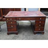 A partners mahogany double pedestal desk, fitted two drawers and cupboards with tooled lined top (