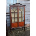 An Edwardian mahogany and inlaid display cabinet enclosed lattice glazed door, on square taper