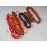 A collection of bead necklaces, including agate, amber, coral and garnet, and a pair of coral ear