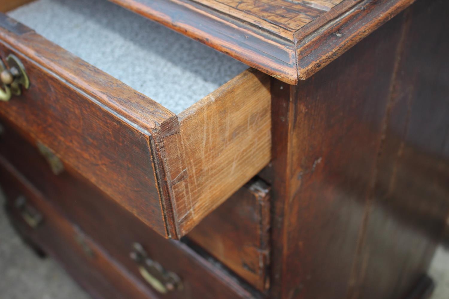 An 18th century oak chest of two short and three long graduated drawers with brass handles, on - Image 4 of 12