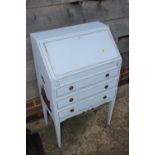 A child's blue painted bureau with painted gilt figure decoration, fitted three drawers, on square