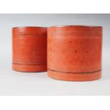 A pair of cylindrical red lacquered boxes, 7 3/4" high