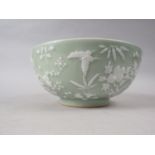 A Chinese porcelain celadon glazed bowl, decorated in high relief with flowers and butterflies, 10