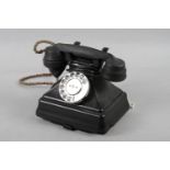 A black cased rotary telephone, No 1/232